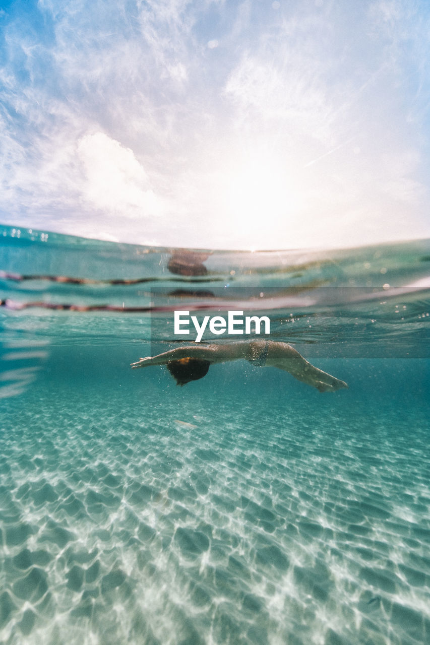 Underwater photo of a relax moment floating in the middle of the paradise of the island of menorca.