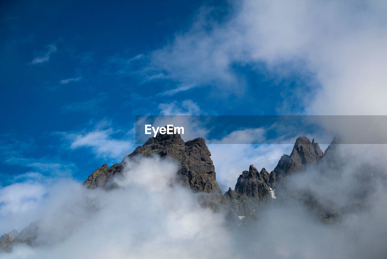 Low angle view of rocks against sky