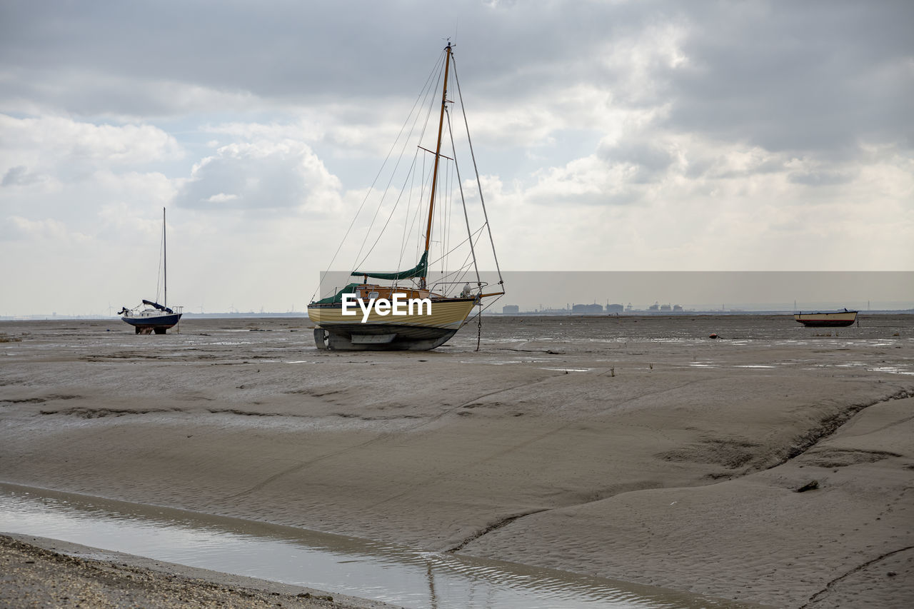 Fisherman boats stuck on the beach in low tide period in leigh-on-sea, uk.