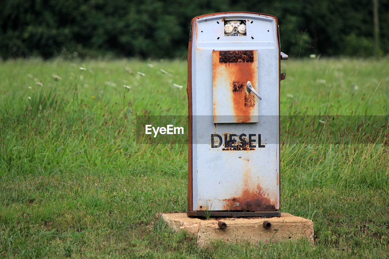 Abandoned fuel pump on grassy field