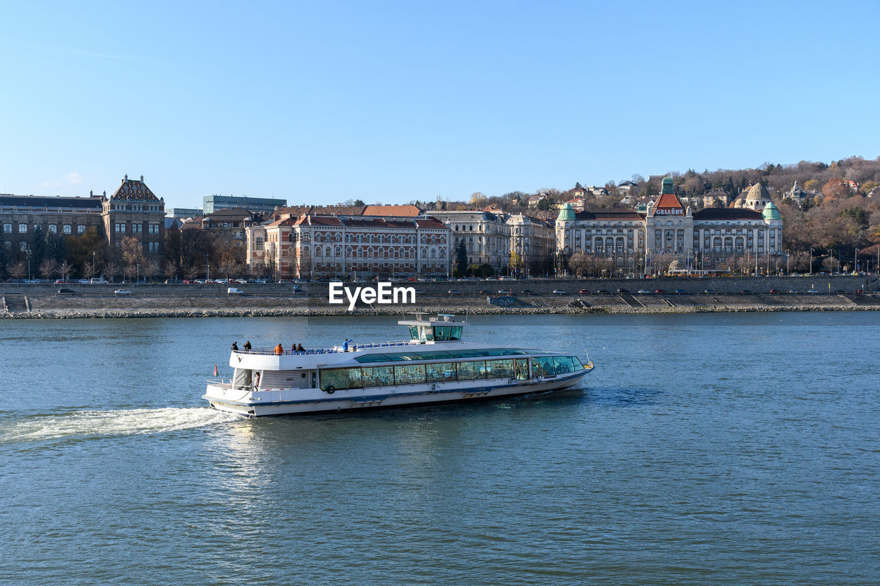 Tourist boat on danube river in budapest, hungary