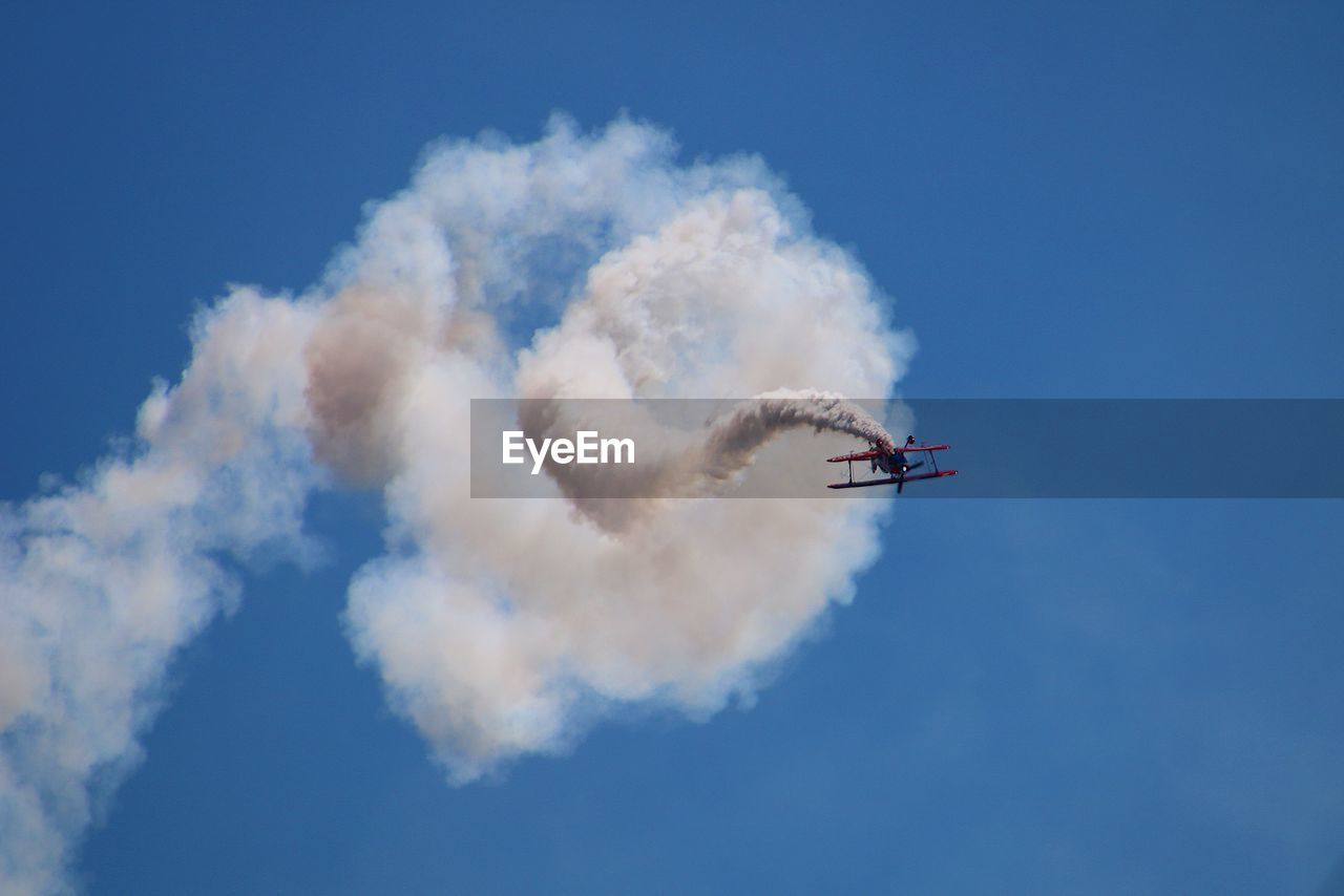 Low angle view of airshow against sky