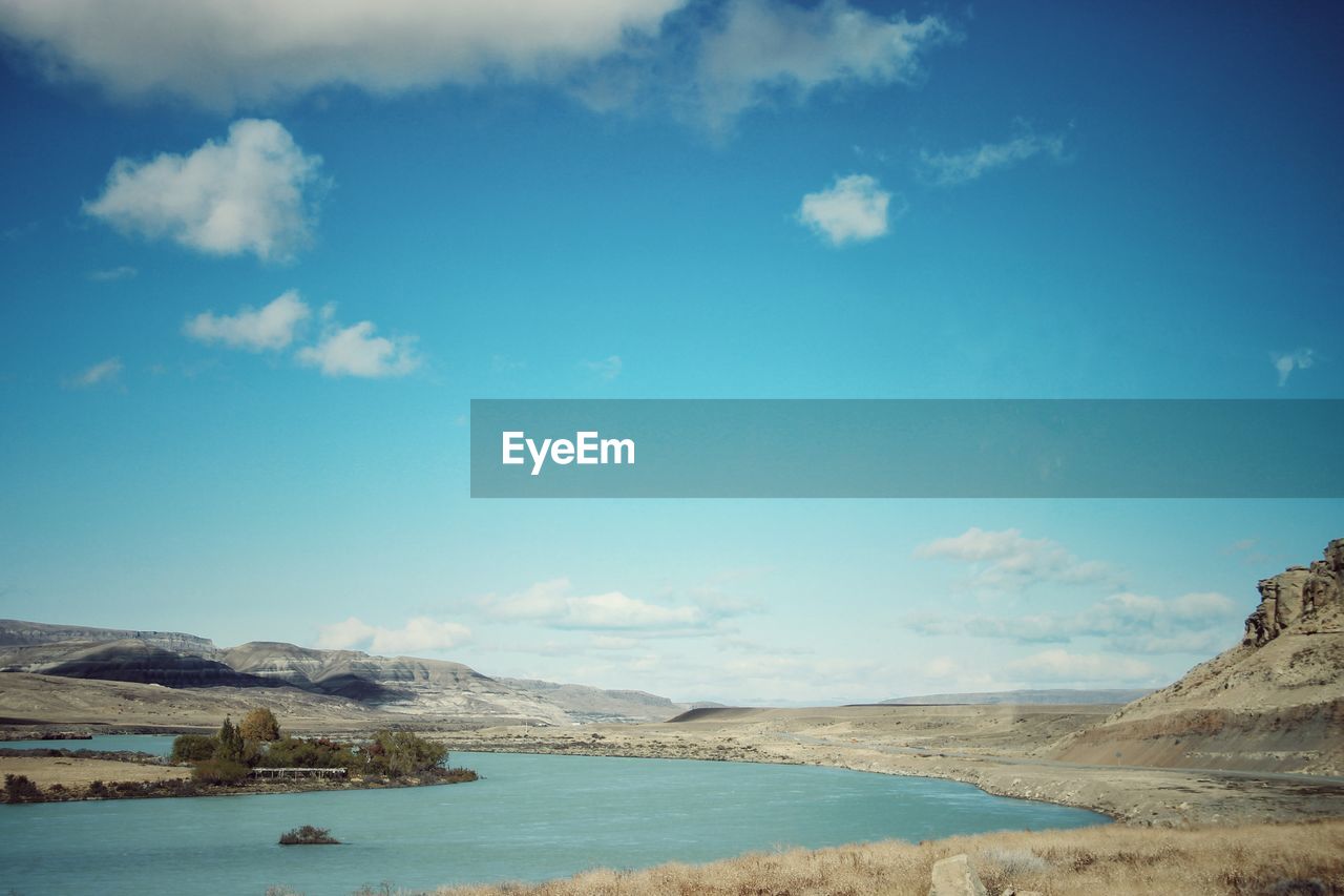 Scenic view of lake against blue sky