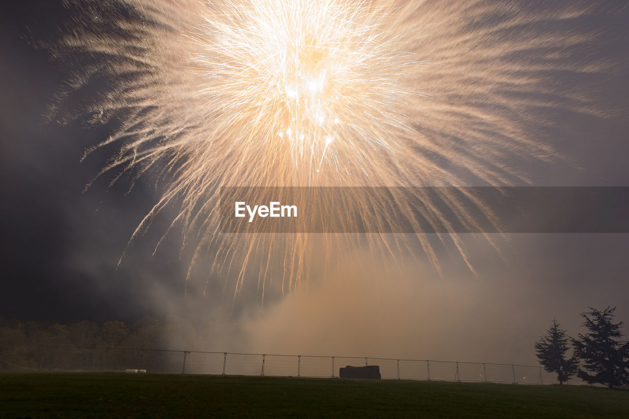 LOW ANGLE VIEW OF FIREWORKS AT NIGHT