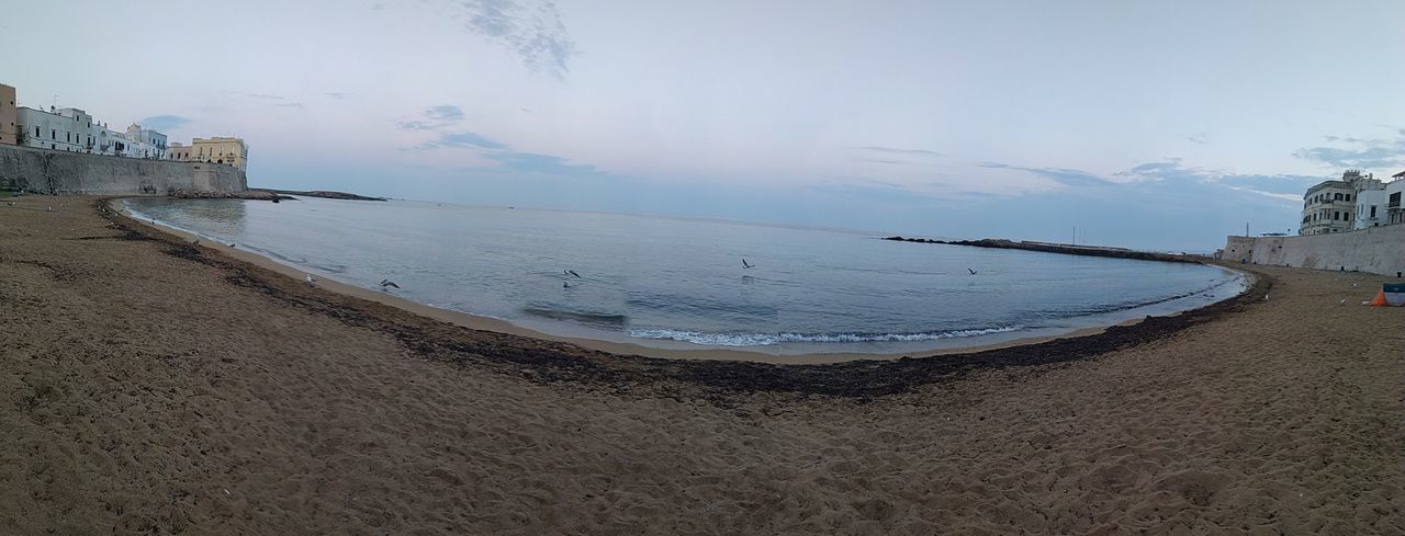 PANORAMIC VIEW OF BEACH AGAINST SKY DURING WINTER