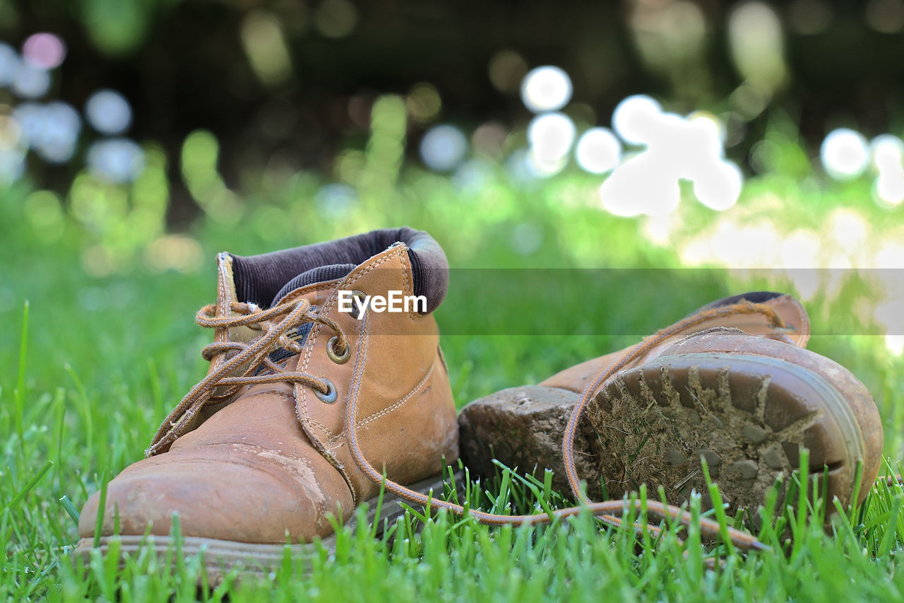 CLOSE-UP OF FRESH SHOES ON GRASS