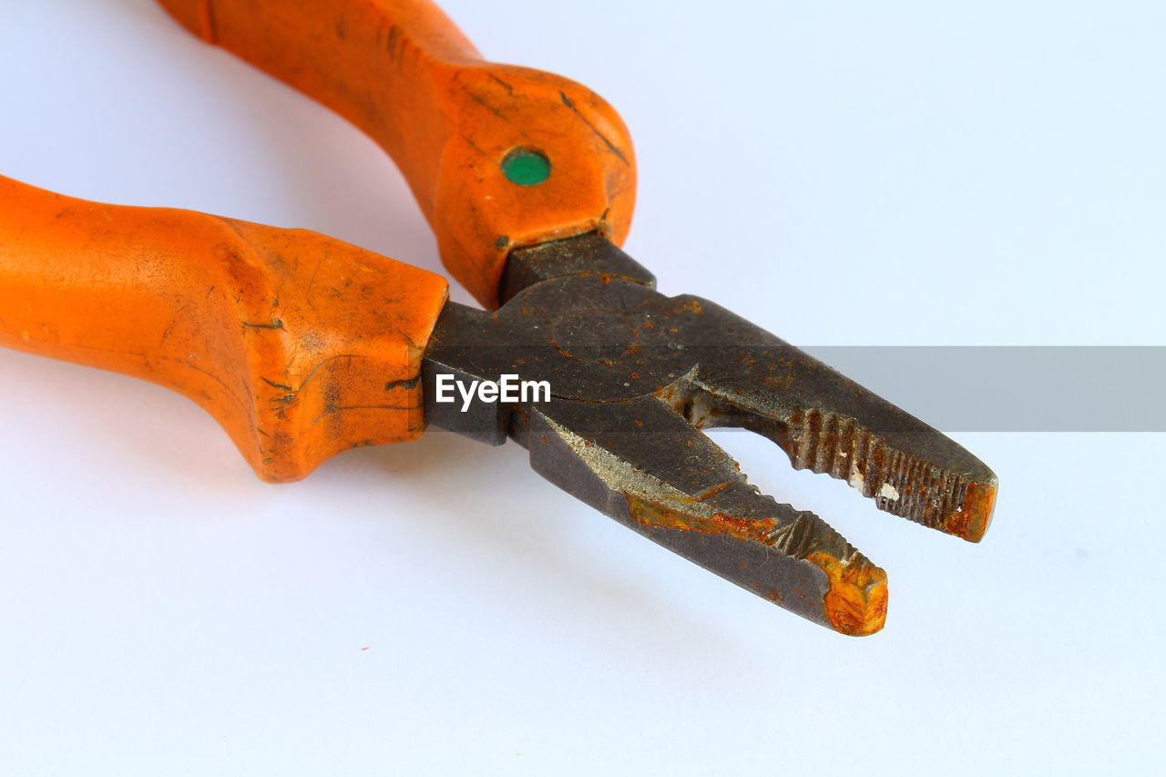 Low angle view of pliers on white background