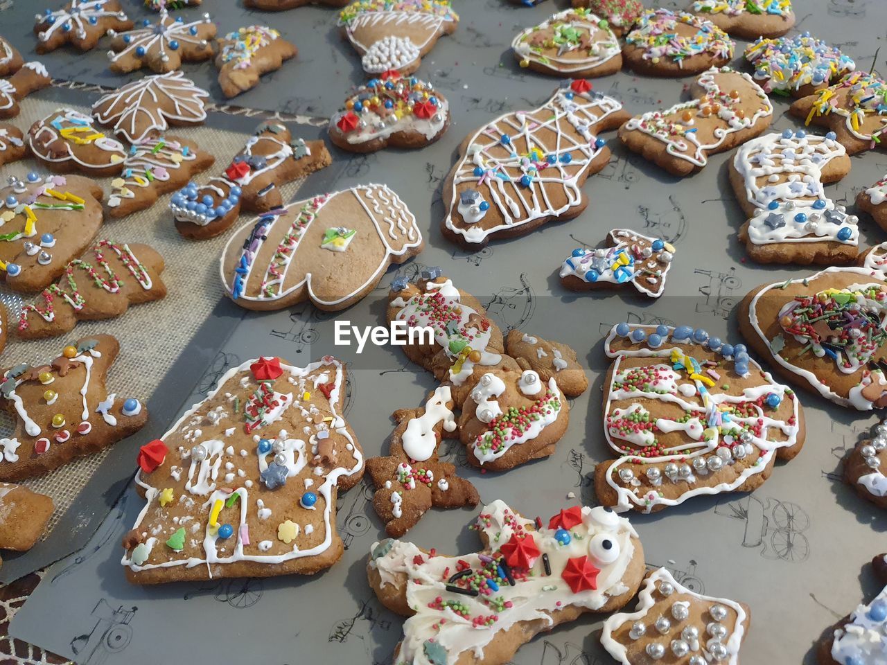 sweet food, food, food and drink, dessert, high angle view, sweet, baked, variation, no people, gingerbread, cookie, large group of objects, still life, freshness, celebration, holiday, temptation, multi colored, table, unhealthy eating, christmas, abundance, icing, day, indoors, gingerbread cookie, event, cake, tradition, shape