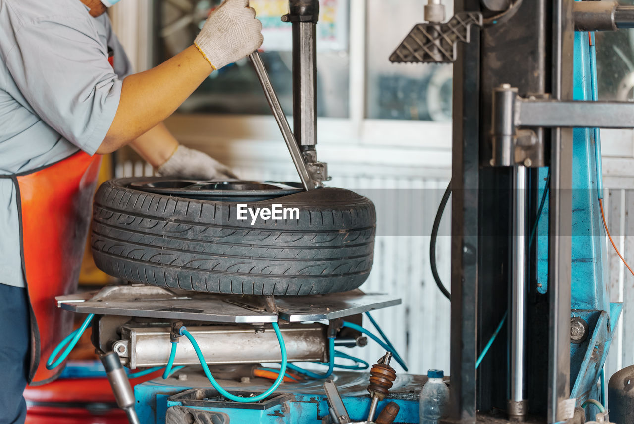 Midsection of man working at garage