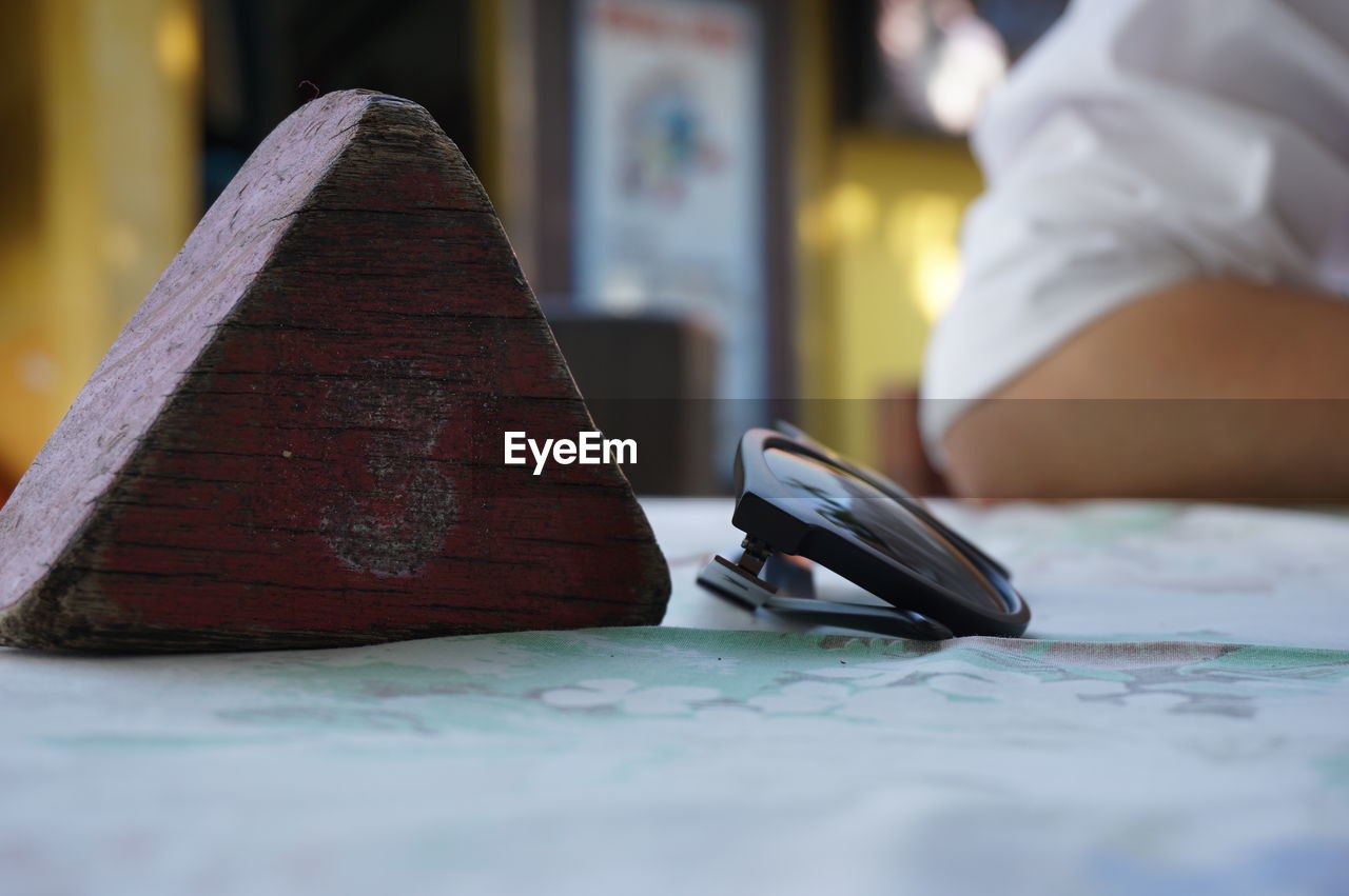 Close-up of sunglasses on tablecloth