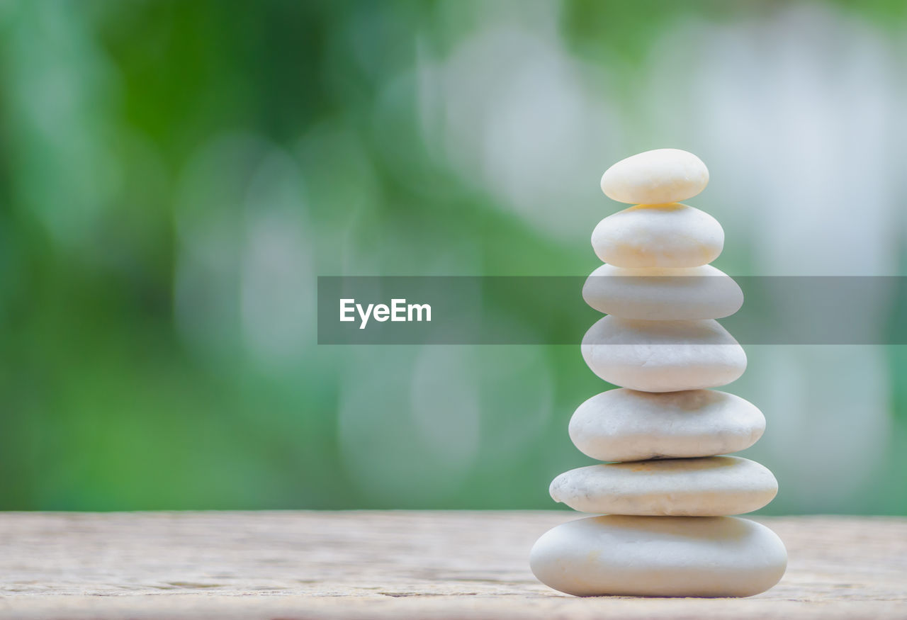 CLOSE-UP OF PEBBLES ON TABLE