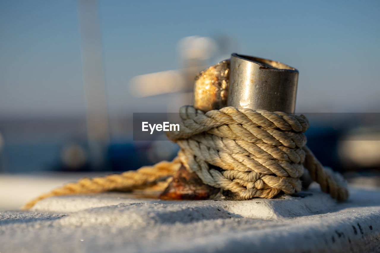 Close-up of rope tied on metal in boat