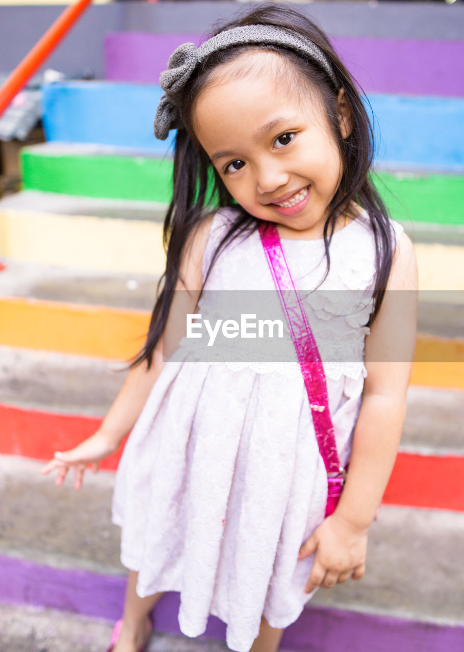 PORTRAIT OF A SMILING GIRL IN A DRESS