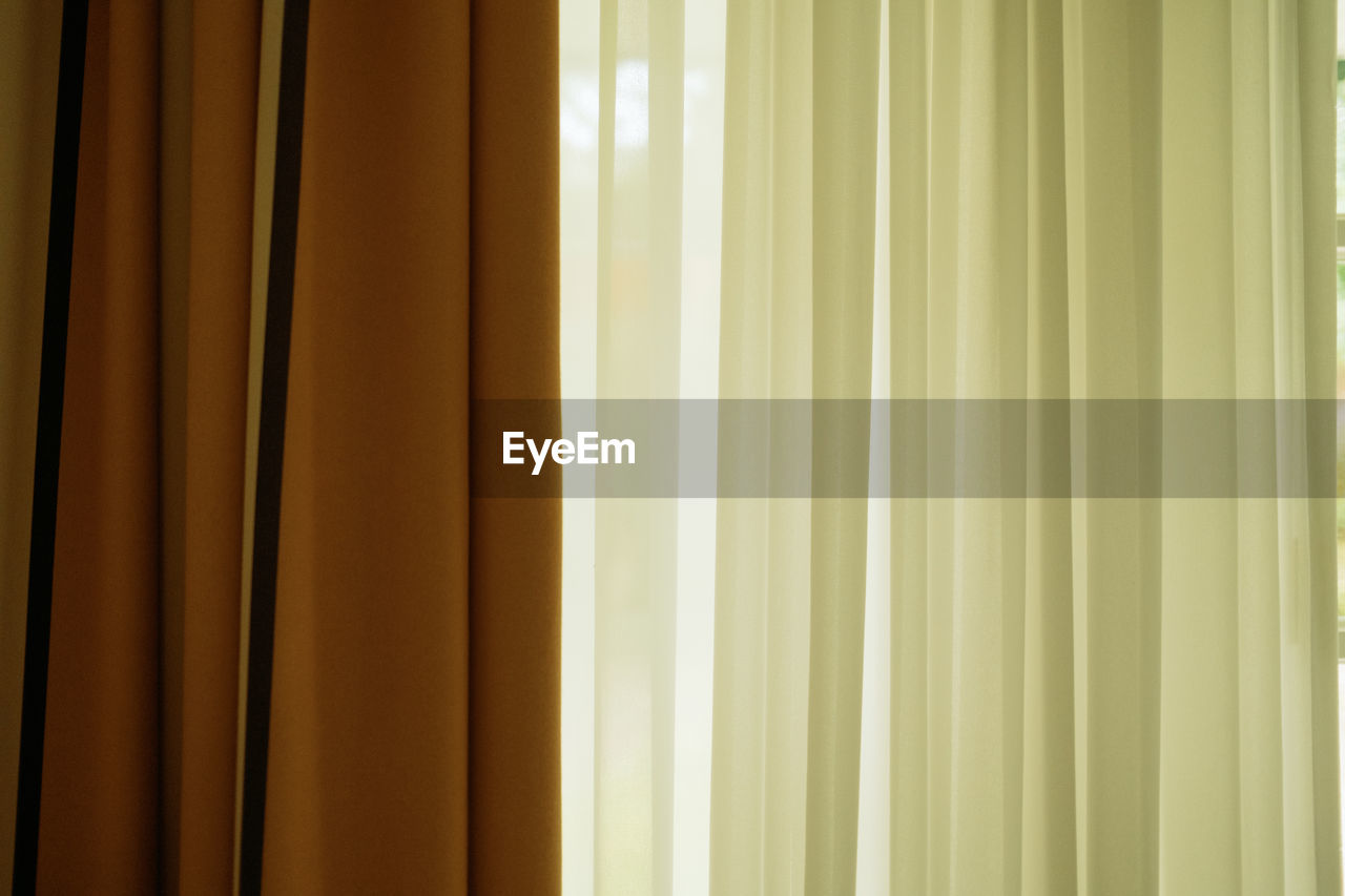 Old white and brown curtain with backlight