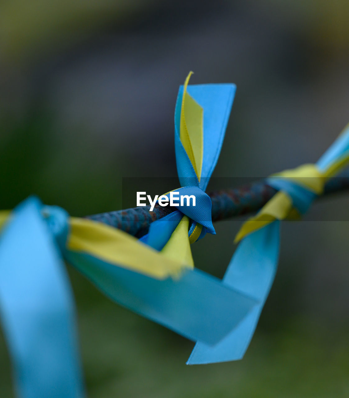 Blue and yellow silk ribbon tied on a metal tube. ukrainian flag symbol, struggle for independence