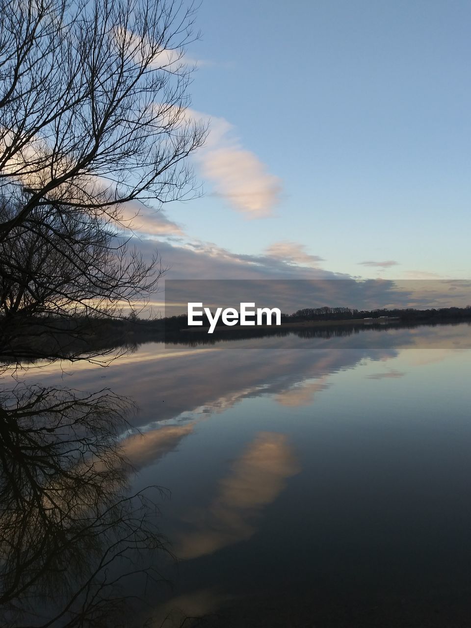 SCENIC VIEW OF FROZEN LAKE AGAINST SKY DURING SUNSET