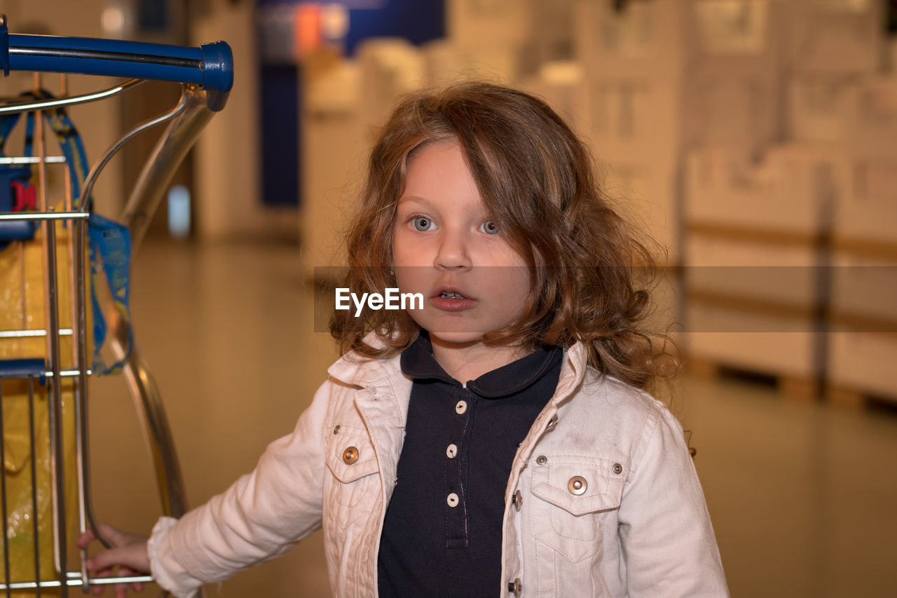 Cute girl looking away at supermarket