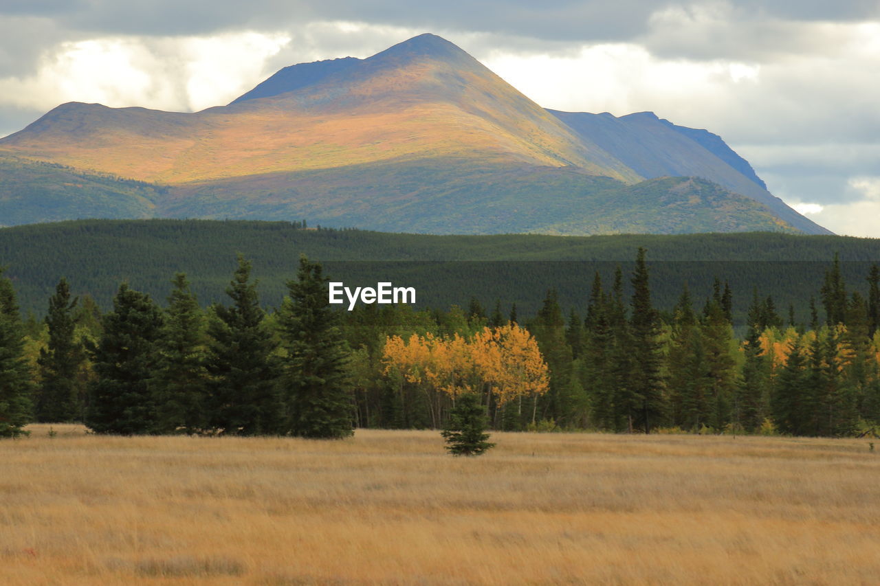 Scenic view of mountains against cloudy sky