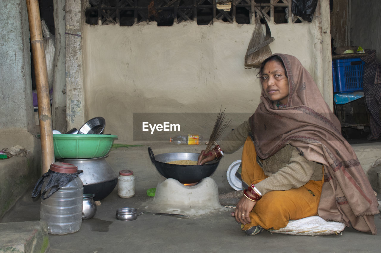 Portrait of woman preparing food at home