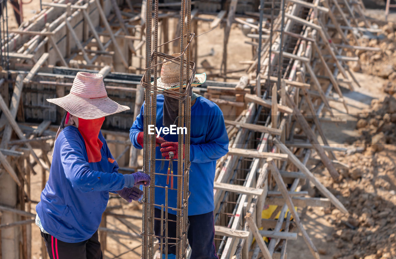 Worker use pile wire bundle steel rod on foundation building in construction site.