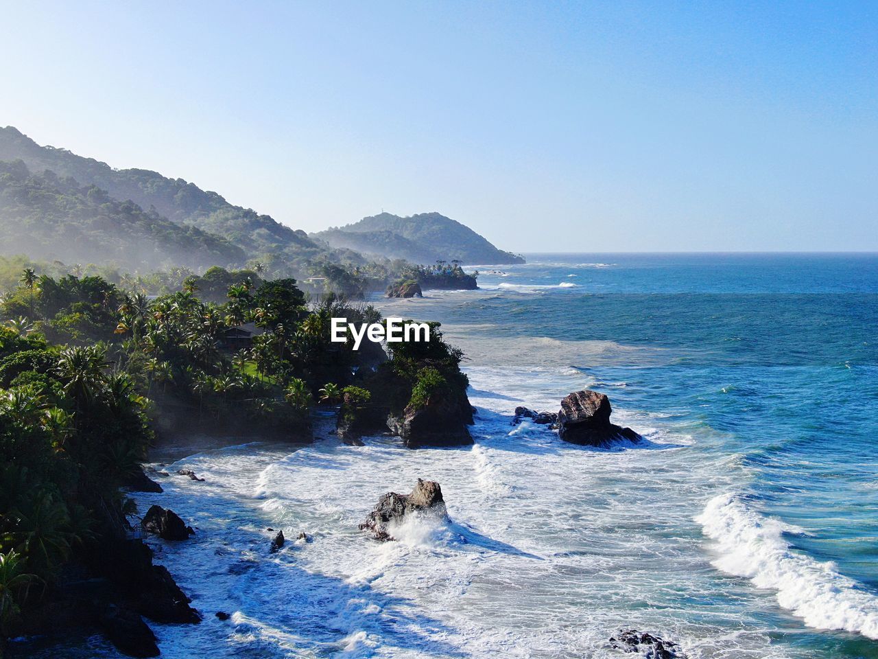 SCENIC VIEW OF SEA AND MOUNTAIN AGAINST CLEAR SKY