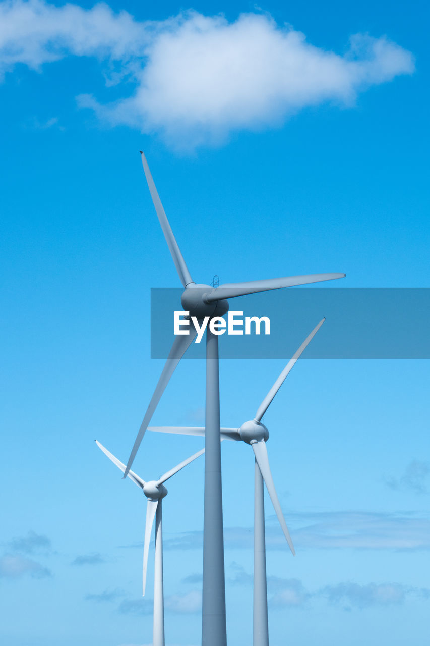 LOW ANGLE VIEW OF WINDMILLS AGAINST SKY