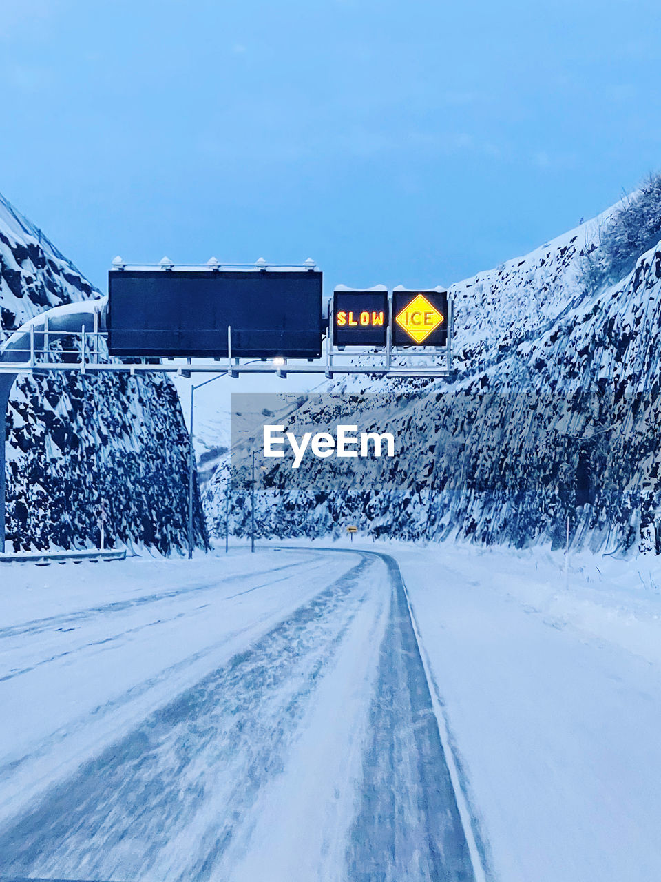 ROAD SIGN ON SNOW COVERED LANDSCAPE