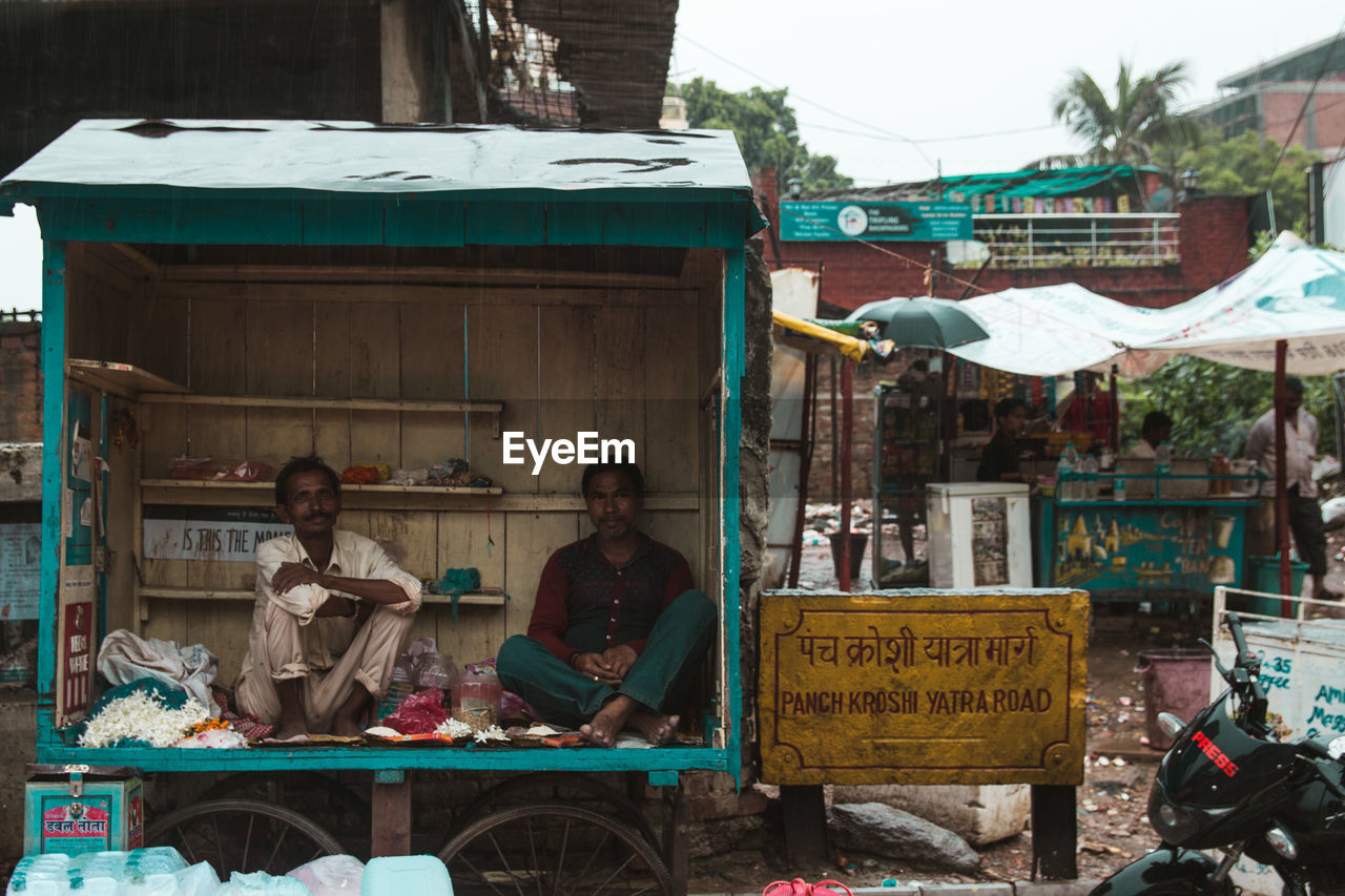 PEOPLE SITTING IN MARKET