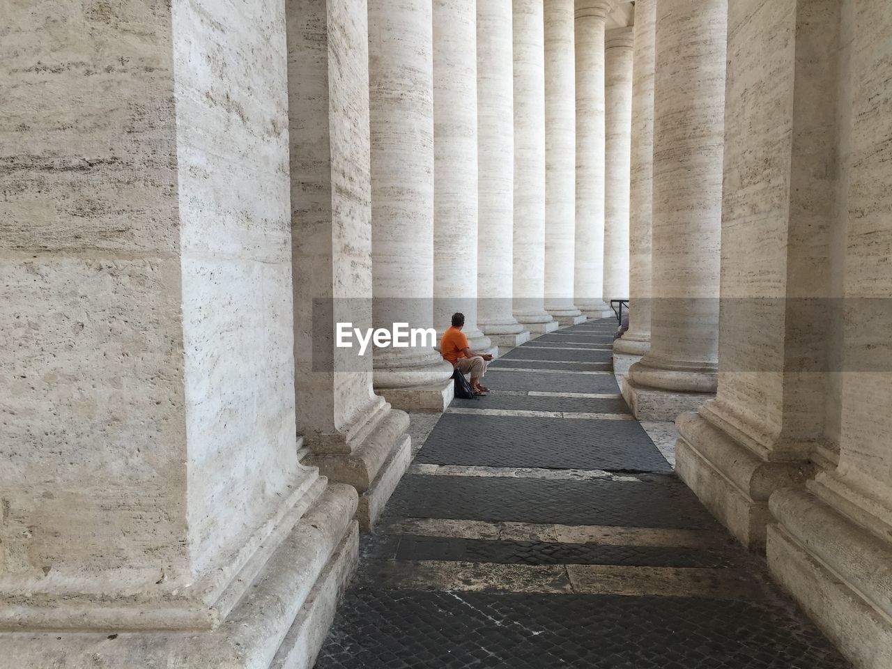 Man sitting in colonnade