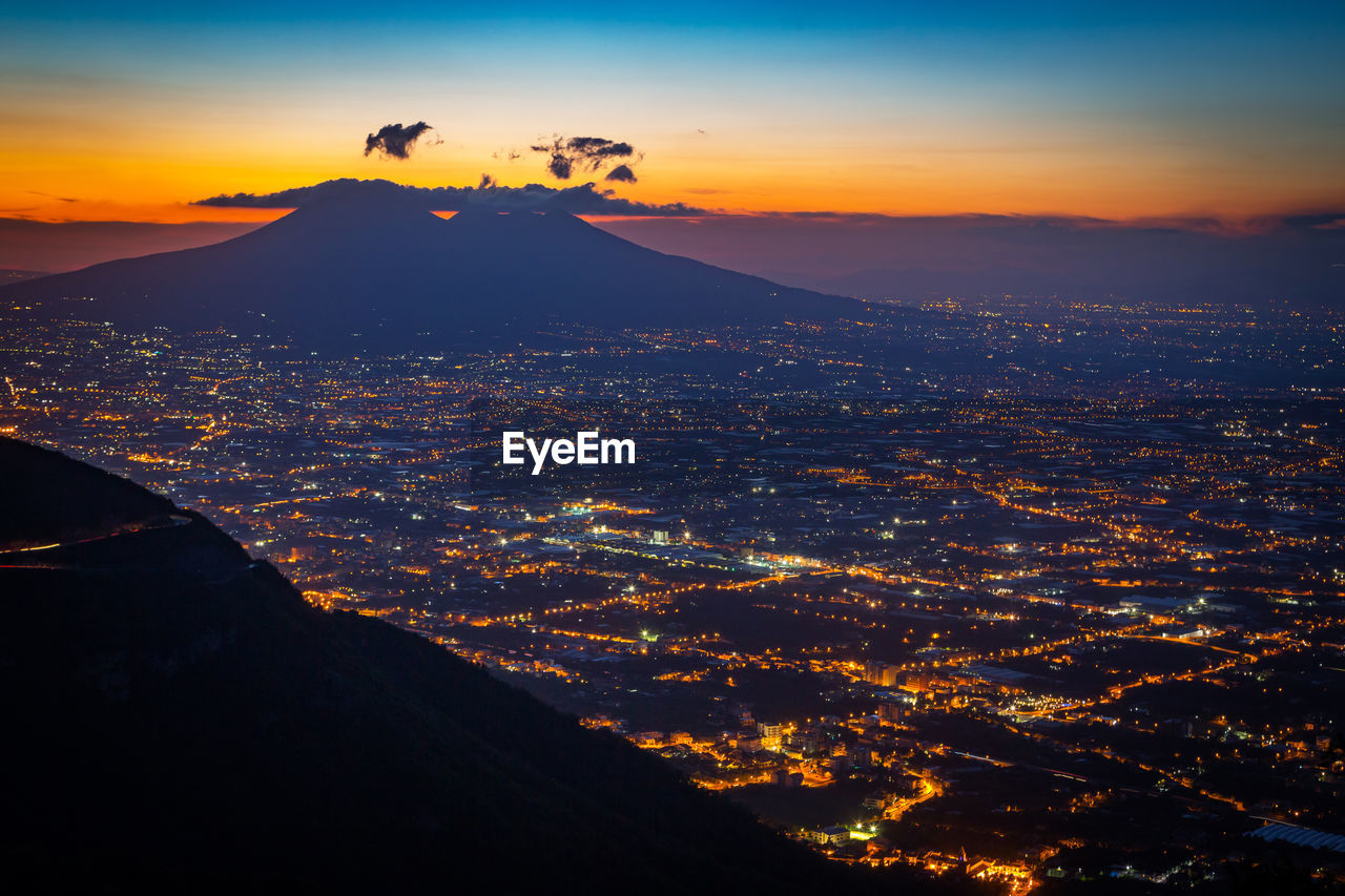 Aerial view of city against sky during sunset