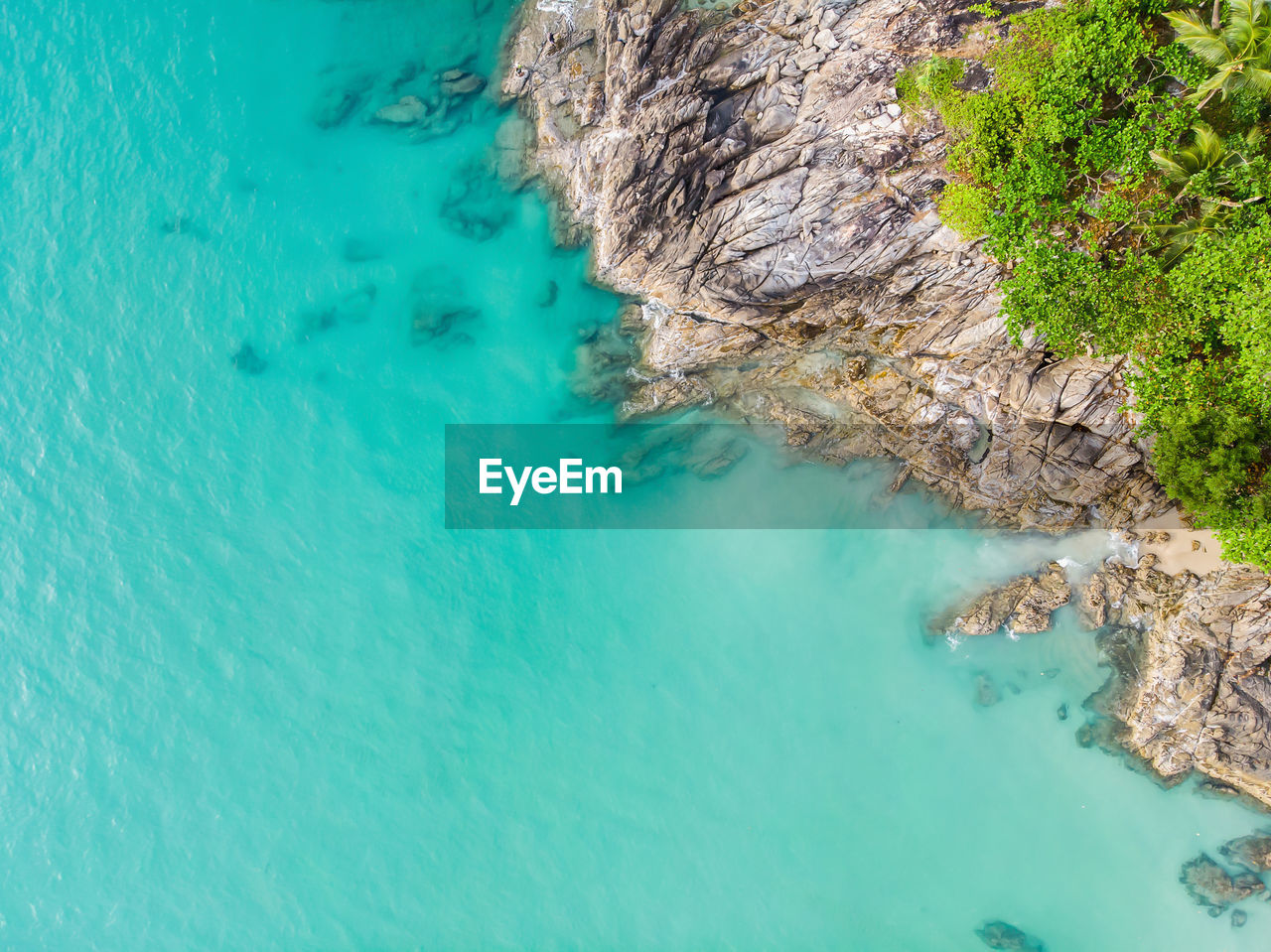 high angle view of rocks on sea