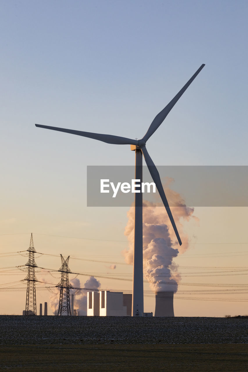 Germany, north rhine westphalia, neurath, wind turbine with lignite power station in background