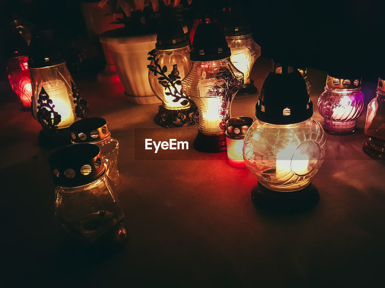 ILLUMINATED LANTERNS ON TABLE