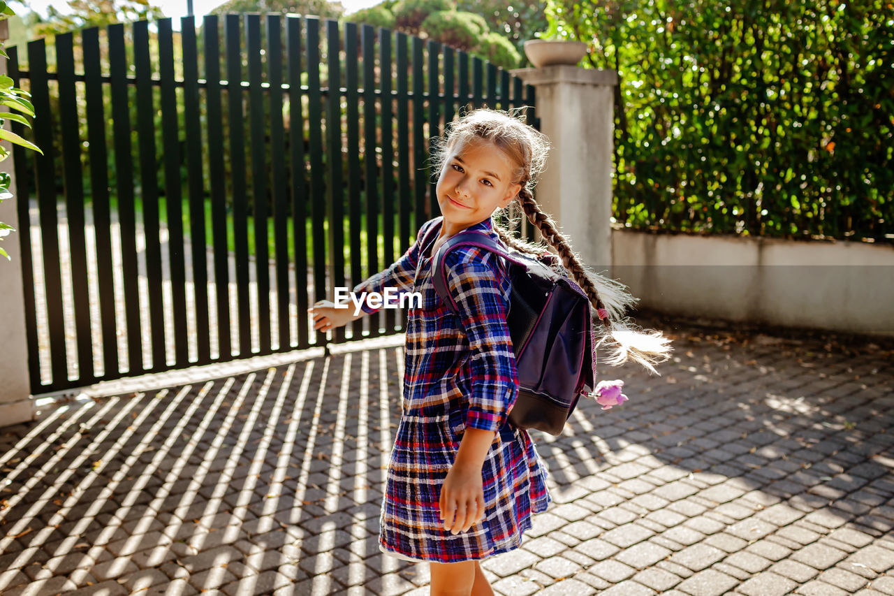 Back to school. girl with backpack runs to school from home at the first day after vacation