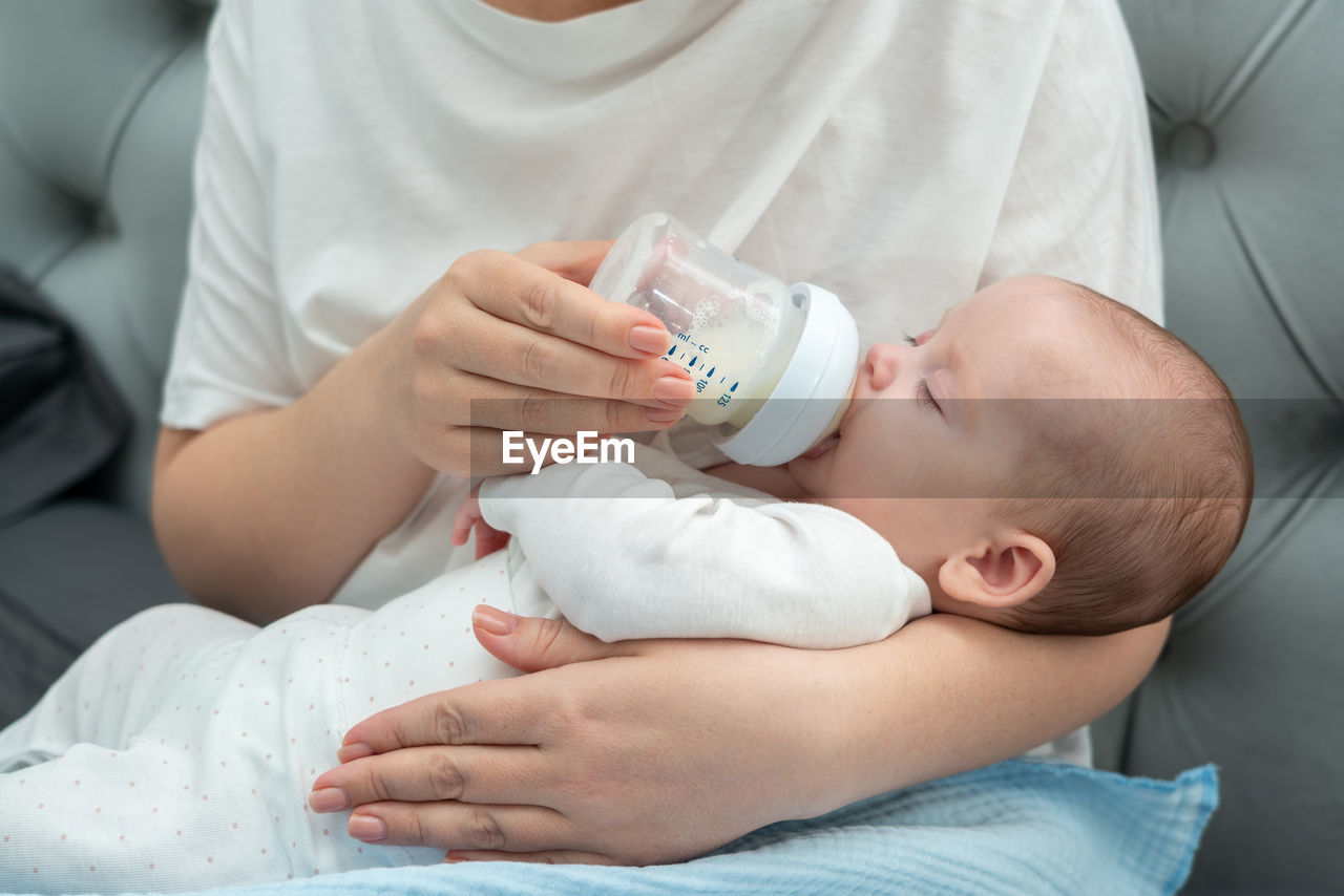 midsection of doctor examining patient on bed