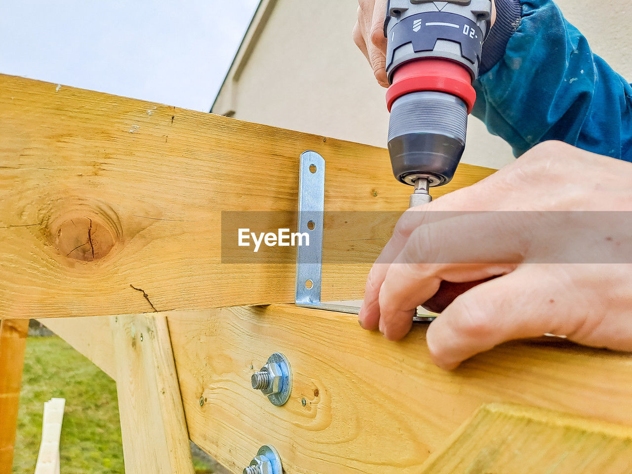 cropped hands of man working on wood