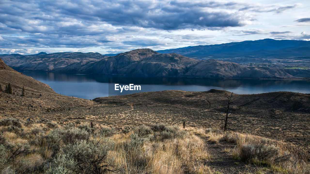 Scenic view of landscape and mountains against sky