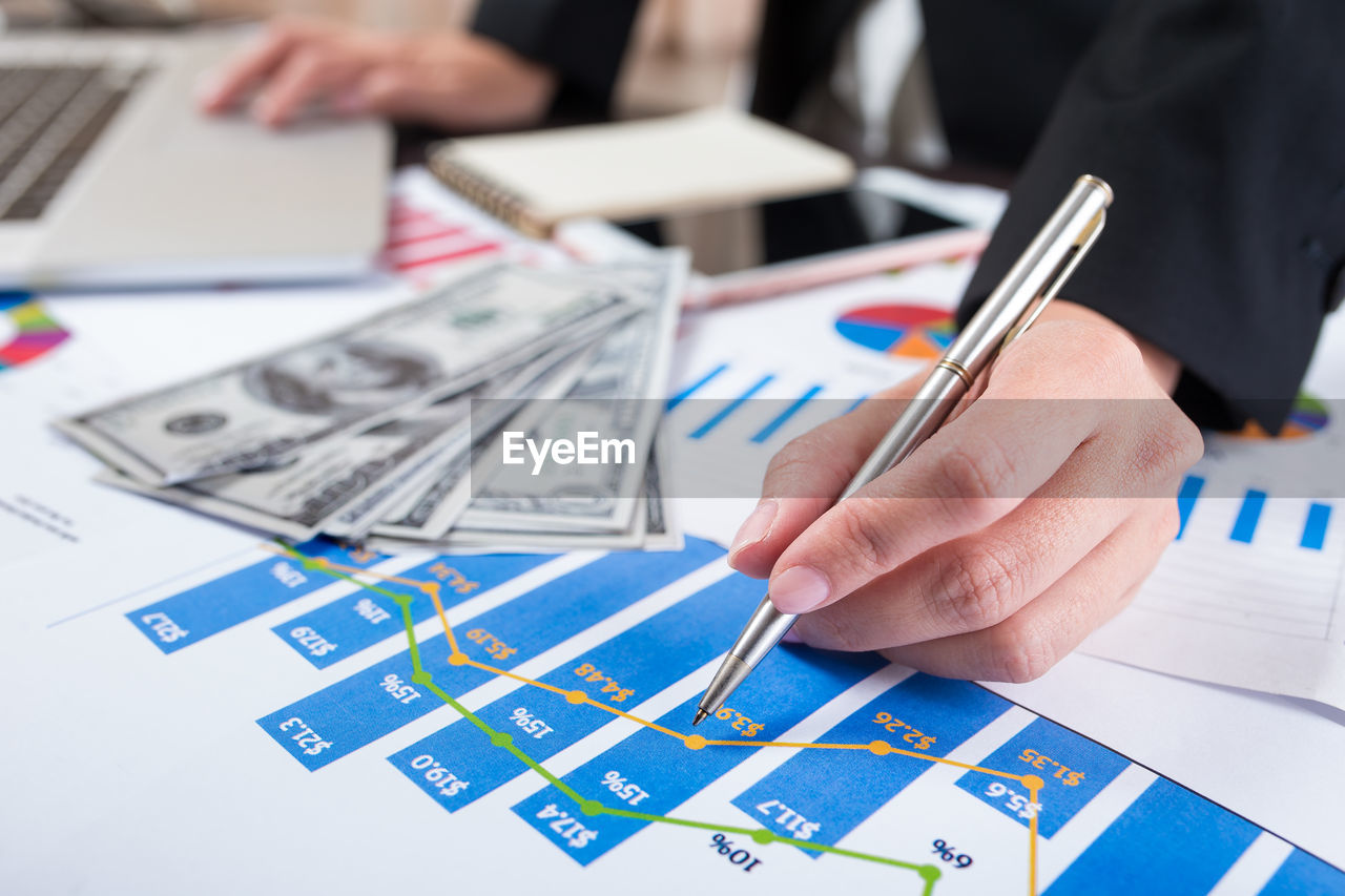 Midsection of business person working over documents at office