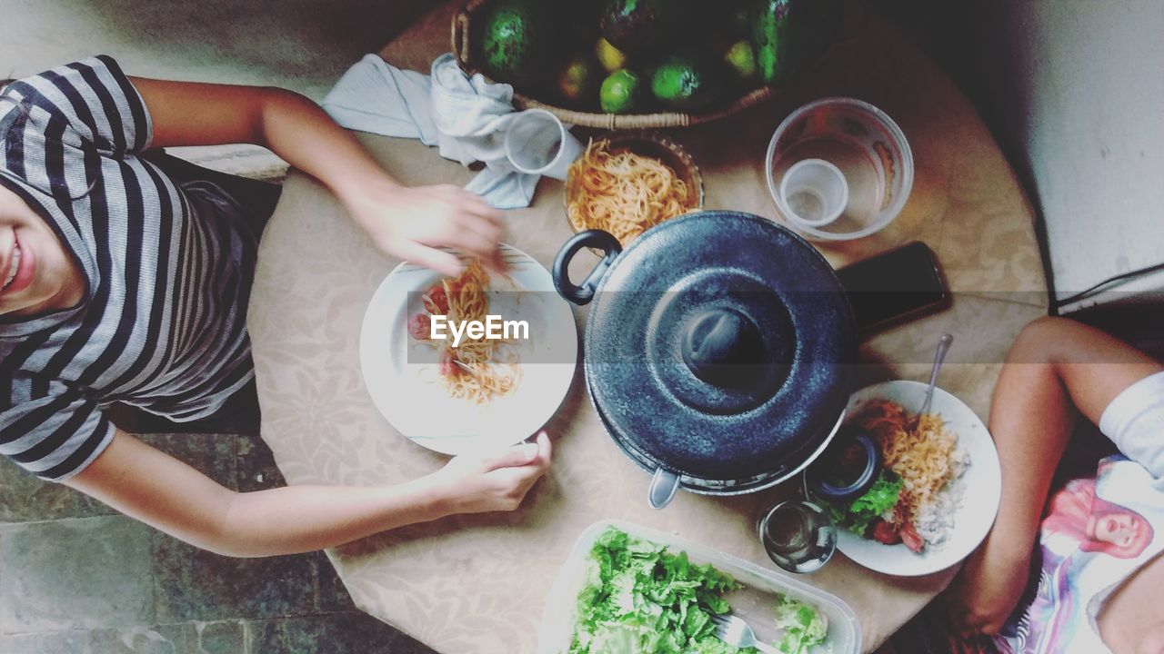 Directly above shot of women sitting at dining table