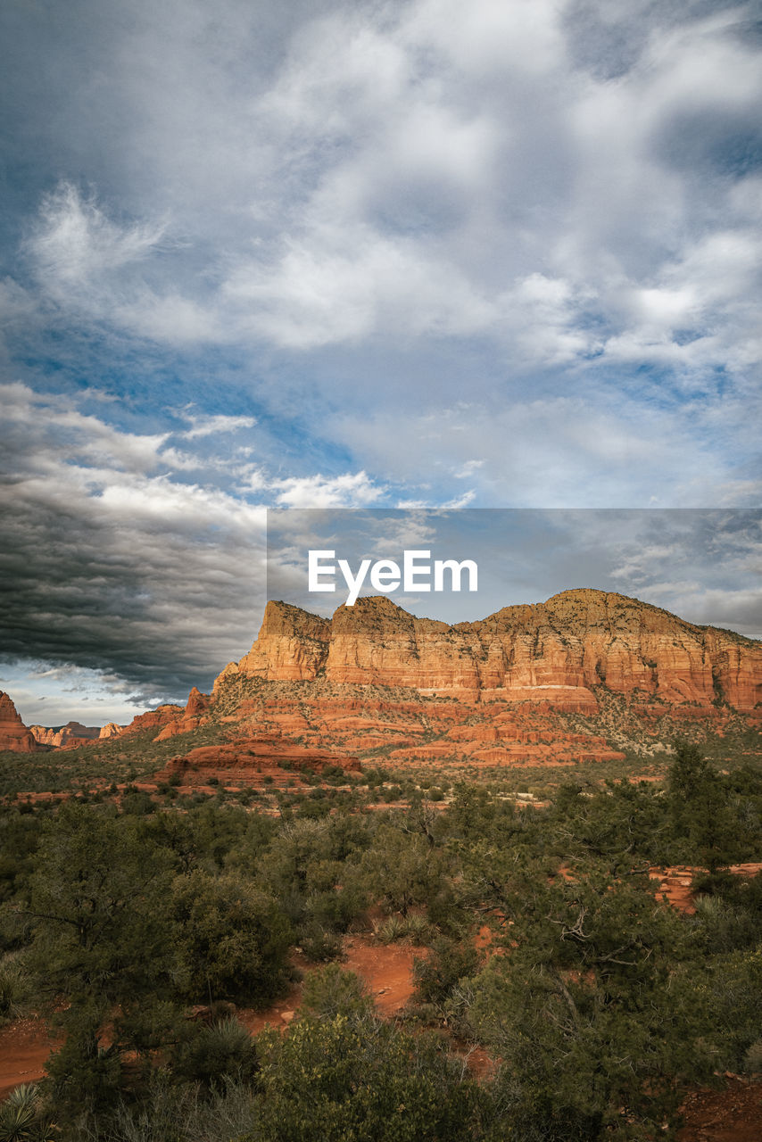 Sunset view of red rock buttes and formations within sedona arizona usa against white cloud. 