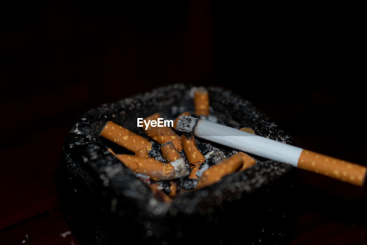 close-up of cigarette in container on table