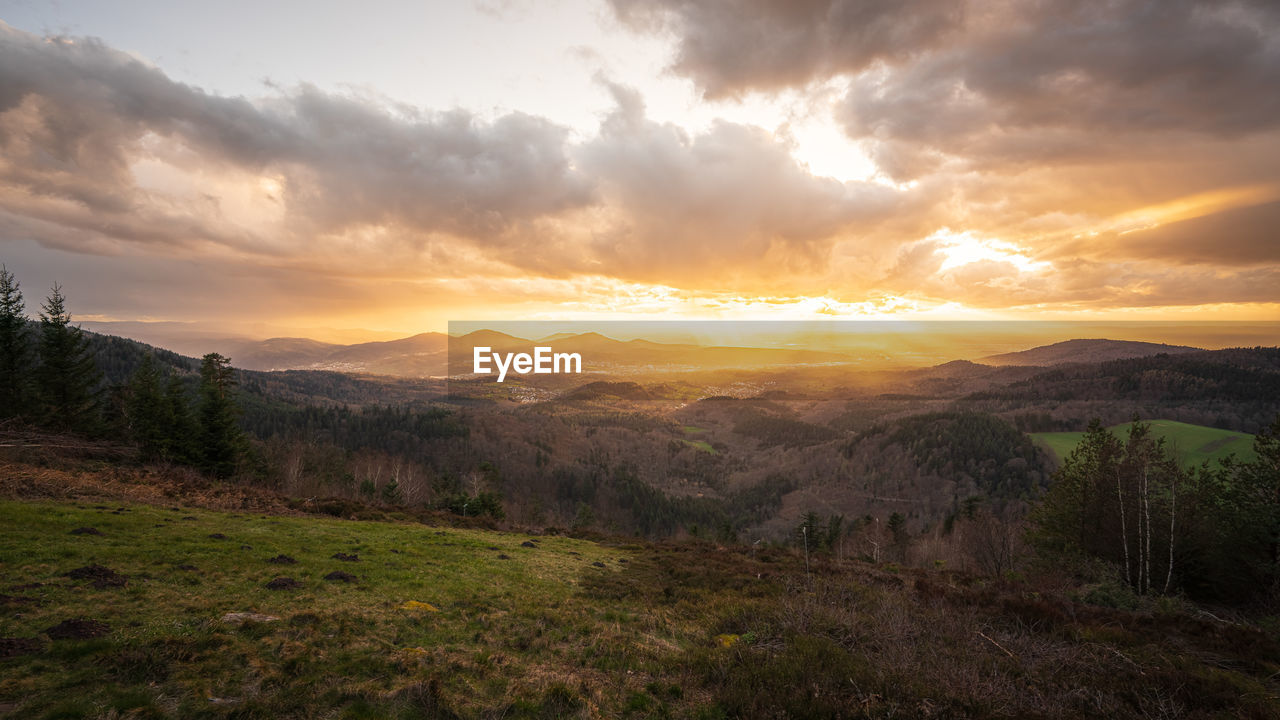 A rain shower passes over the murg valley in the northern black forest during the golden hour