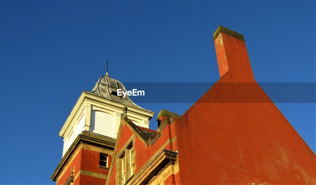 architecture, built structure, building exterior, sky, blue, clear sky, landmark, tower, building, no people, nature, low angle view, religion, place of worship, history, belief, the past, sunny, travel destinations, steeple, day, outdoors, spirituality, city, facade, temple, sunlight, travel, house