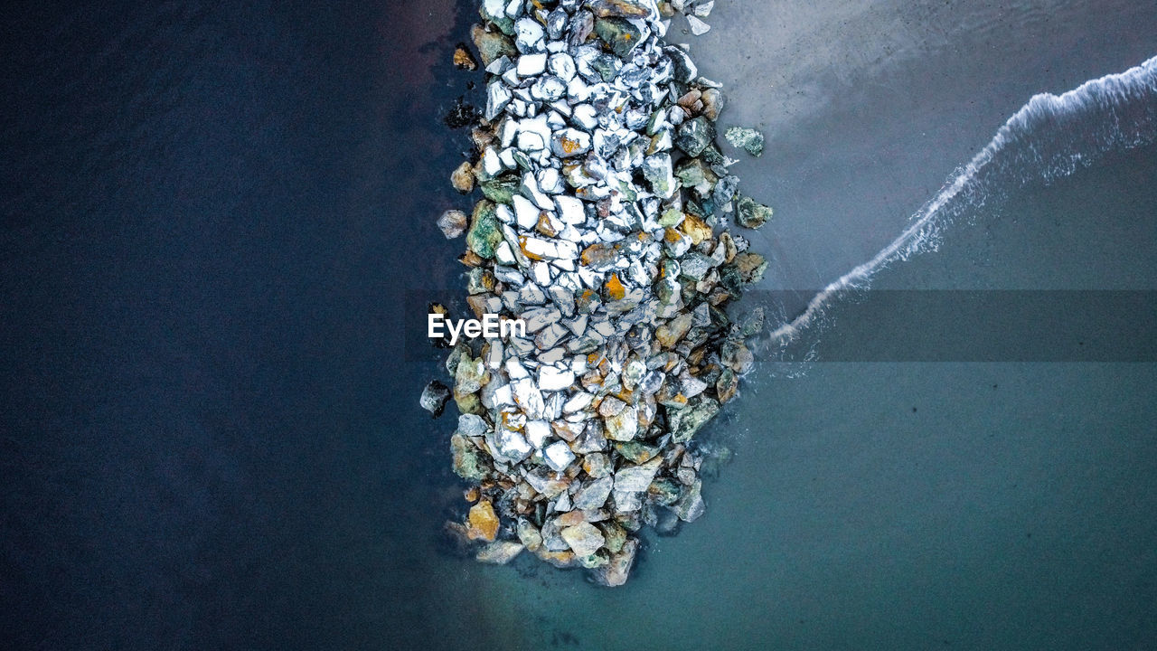 High angle view of sea against breakwater