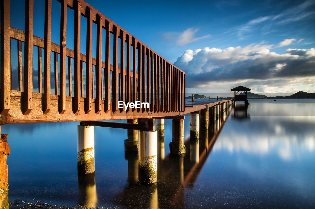 Pier over river against sky