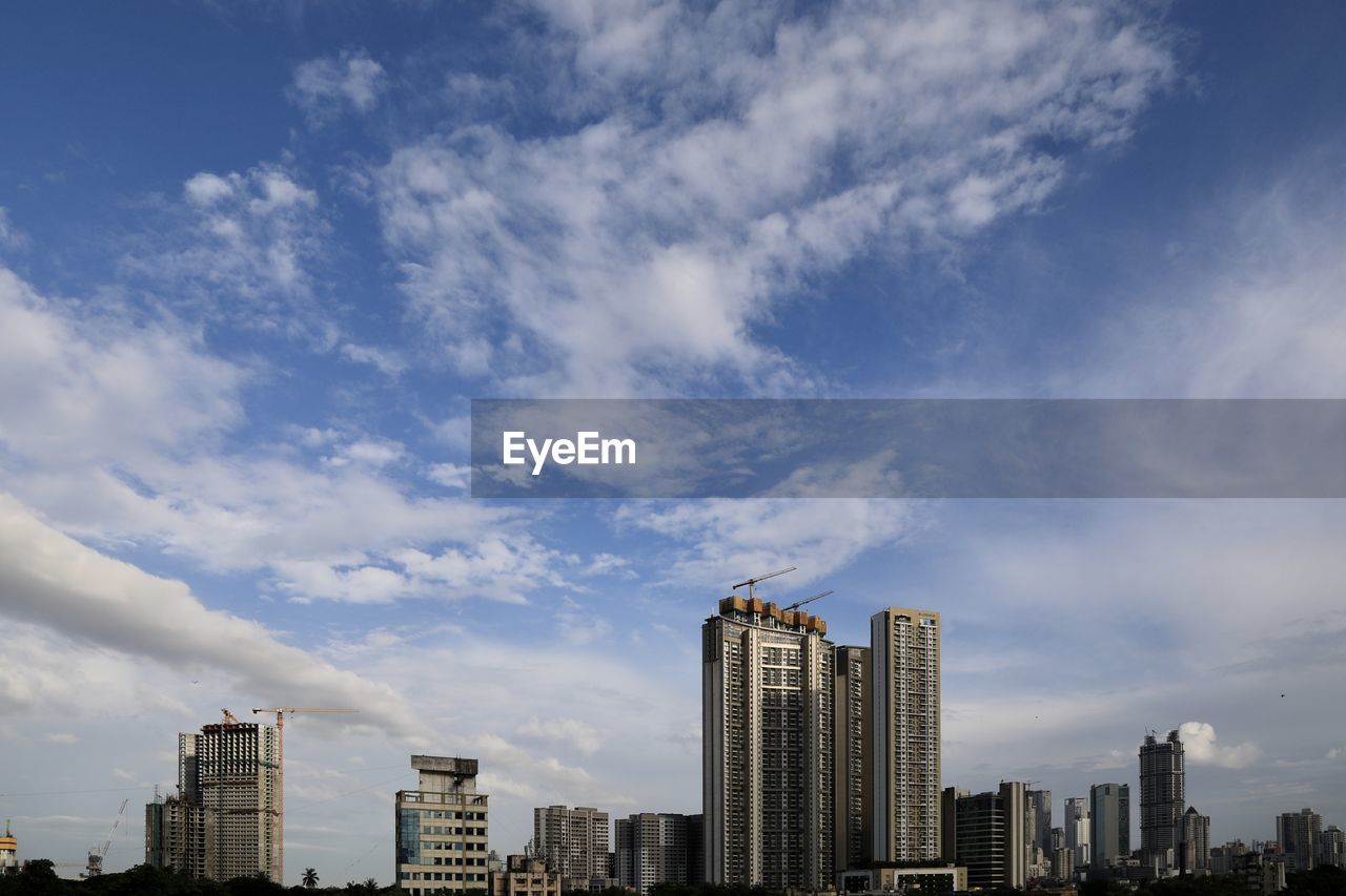 Modern buildings in city against sky