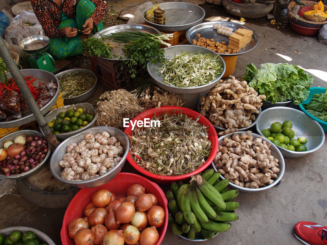 Midsection of vendor selling vegetables in market