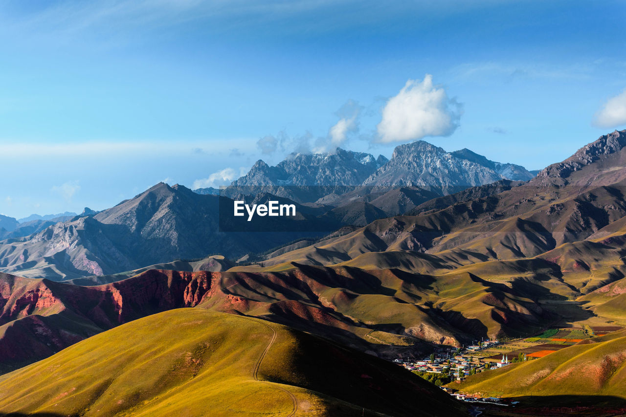 Scenic view of mountains against cloudy sky