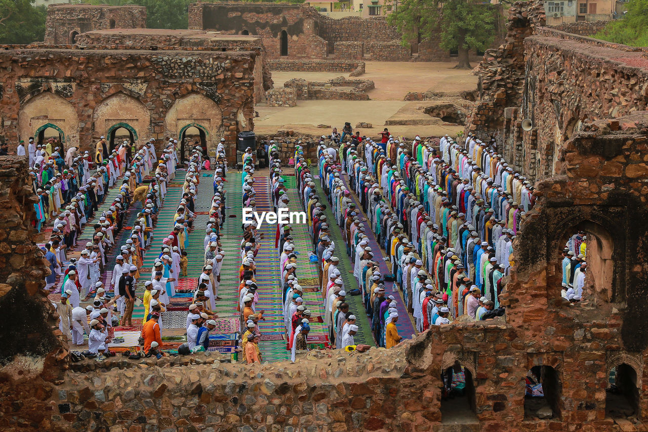 Muslims pray as others take part in eid al-fitr prayers in the ruins of the feroz shah kotla 