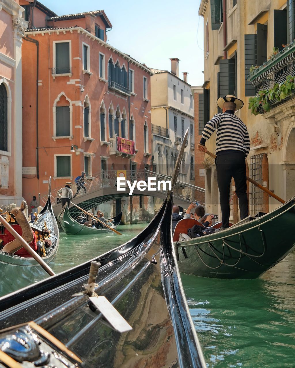 People traveling by gondolas in canal